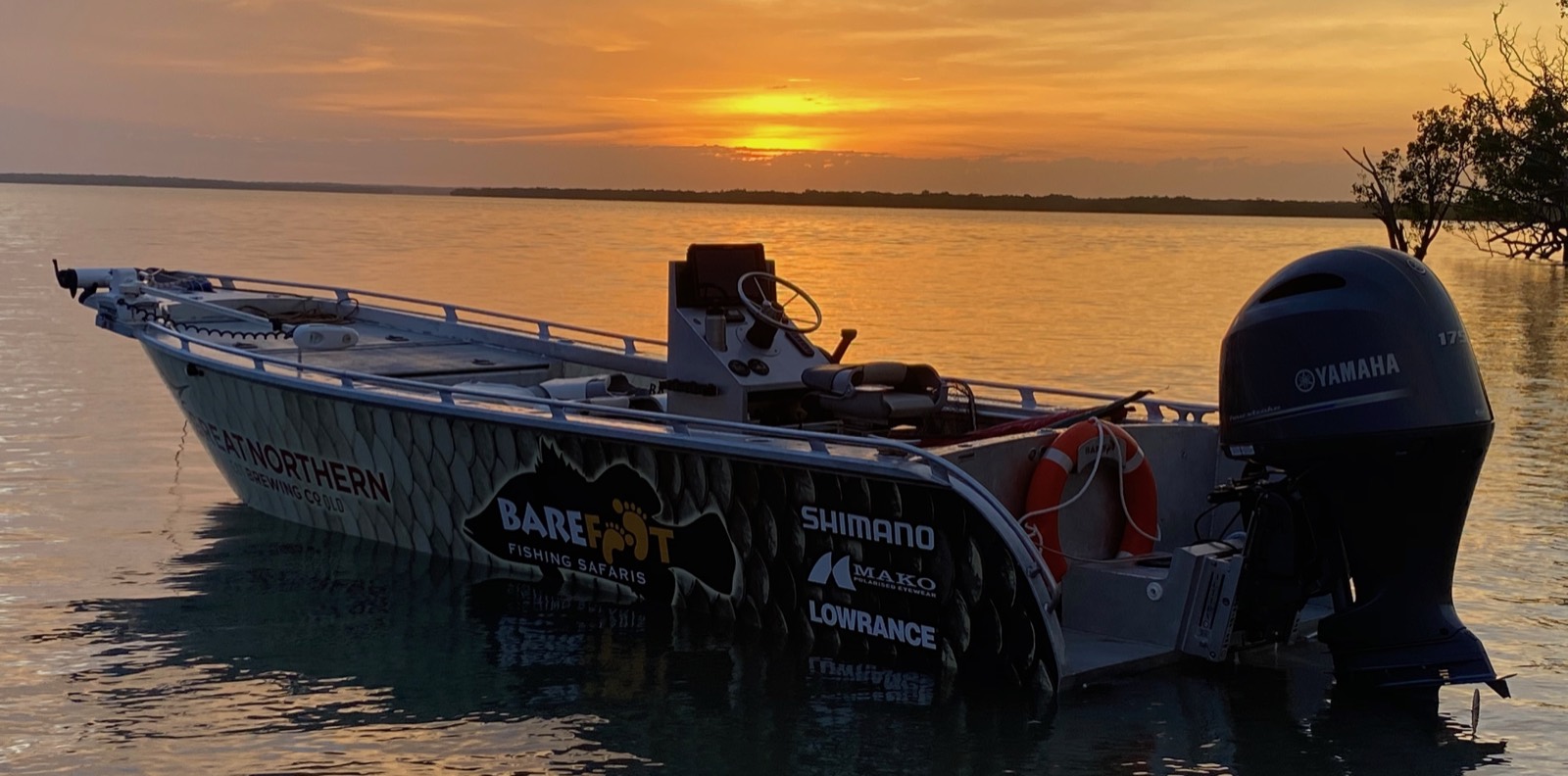 The Barefoot boat sitting on still water at sunset in the Top End
