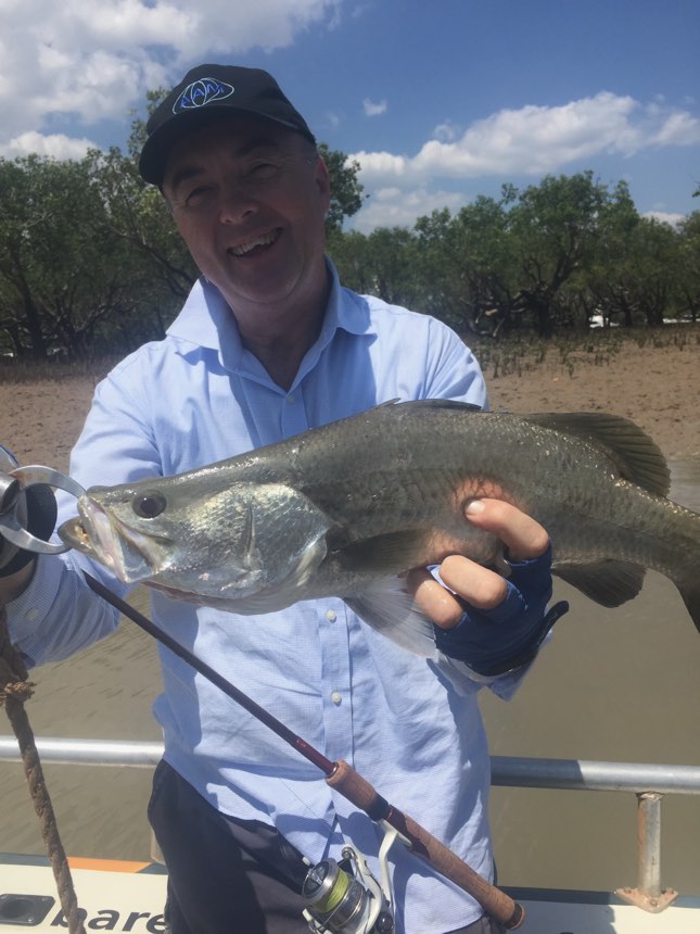 Angler on a Barefoot boat with a barra