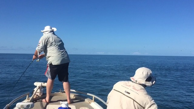 An angler casting from the bow on a flat morning