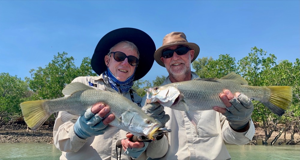 Two fly anglers with a double hook-up of barramundi