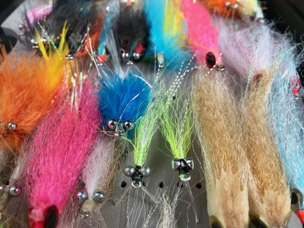 A tray of big colourful saltwater flies tied for Top End barra and pelagics