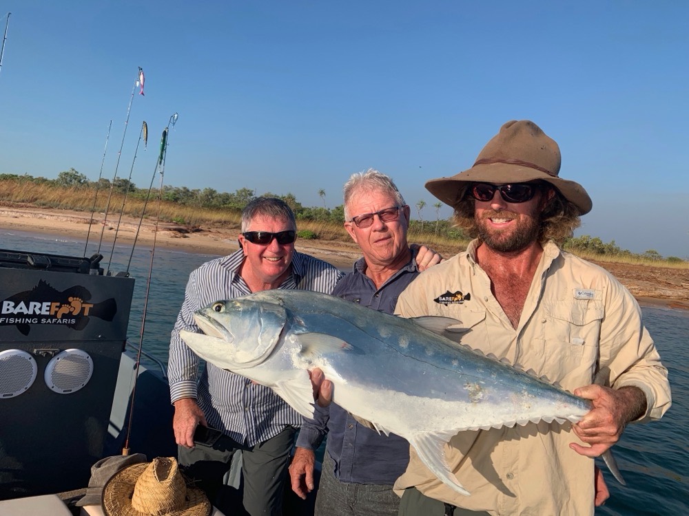 Three mates on the Barefoot boat with a big queenfish