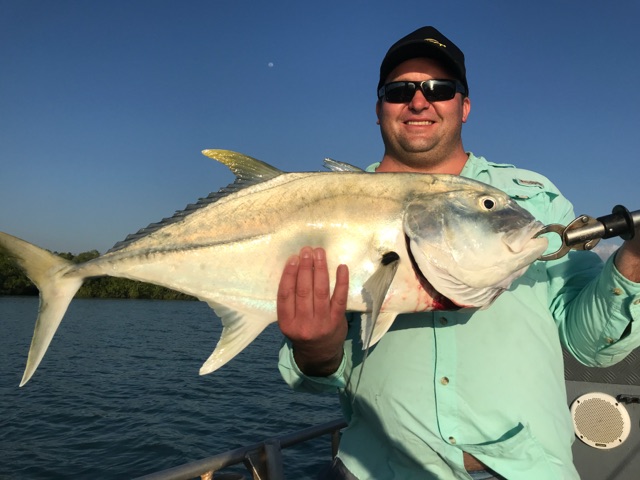 Giant trevally boatside in the sun, caught on fly