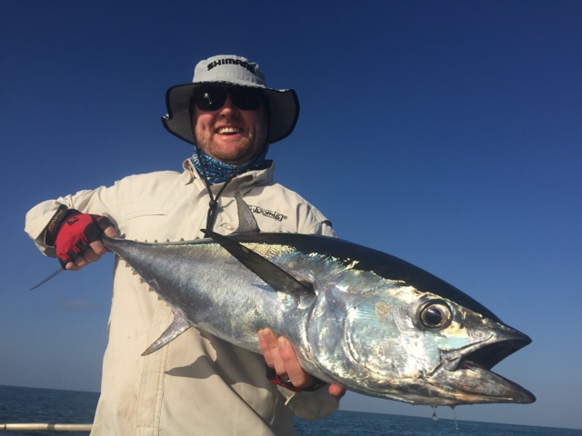 Longtail tuna held across the gunwale