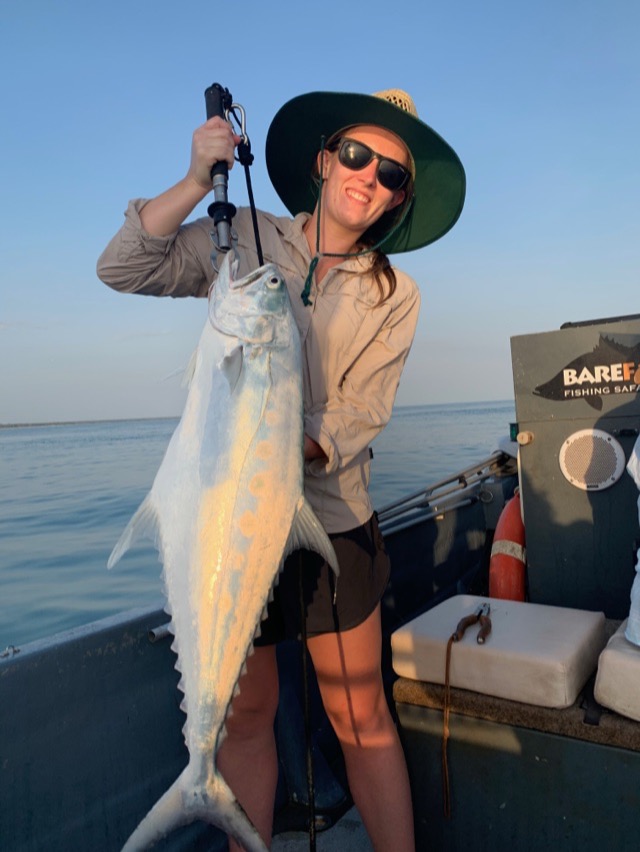 Angler bracing against a queenfish caught on the fly