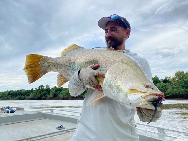 Angler with a deep-bodied golden barra